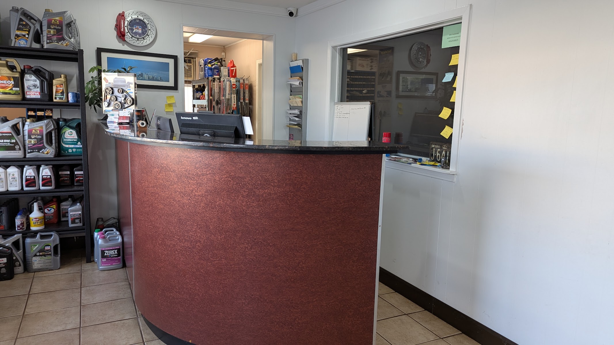 Front counter at Nainar Auto Service with motor oils and accessories on the shelves
